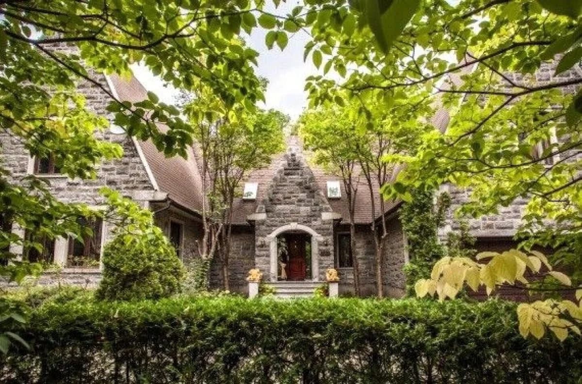 Cartierville Riverside House — stone exterior and garden